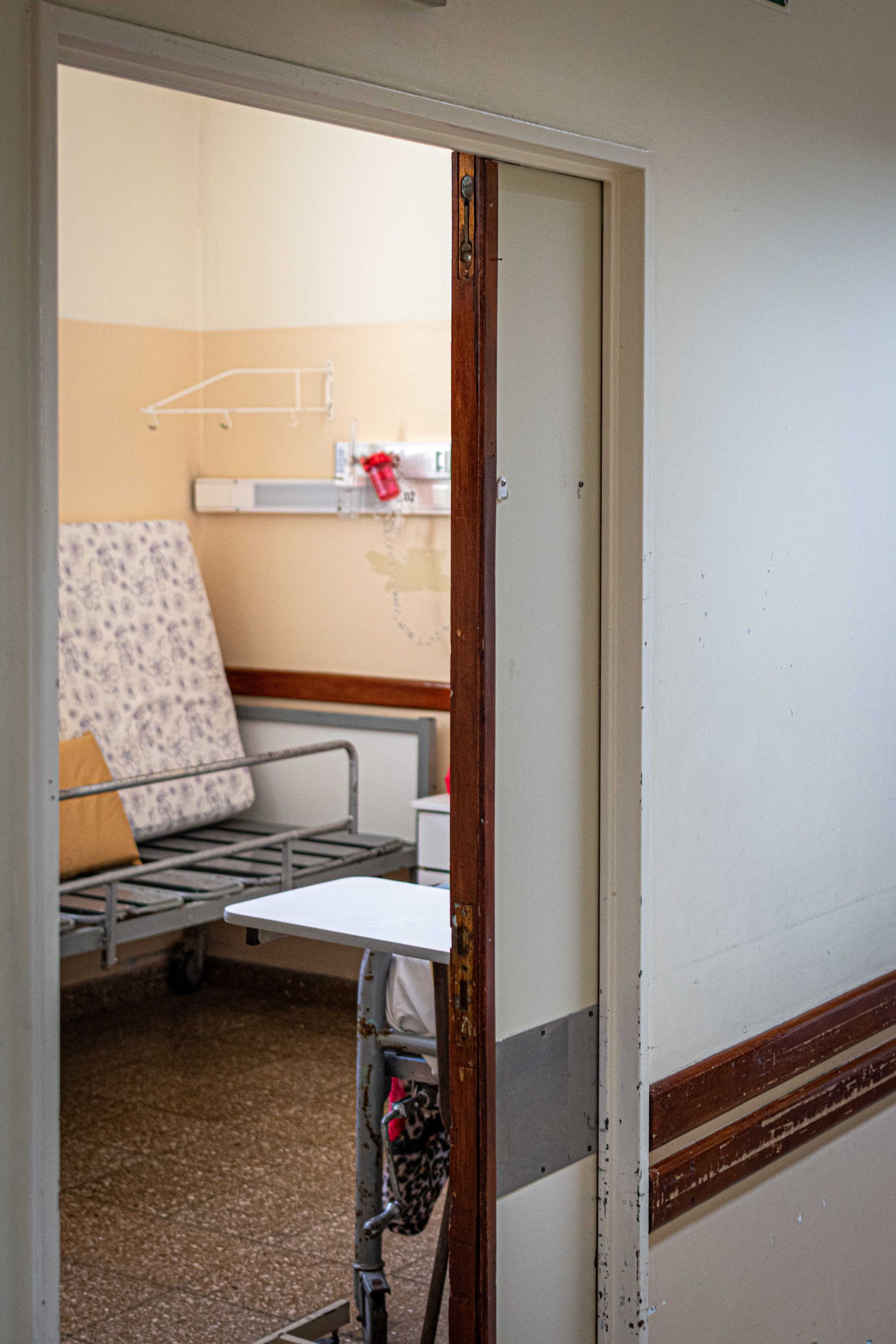 An empty hospital room seen through an open doorway