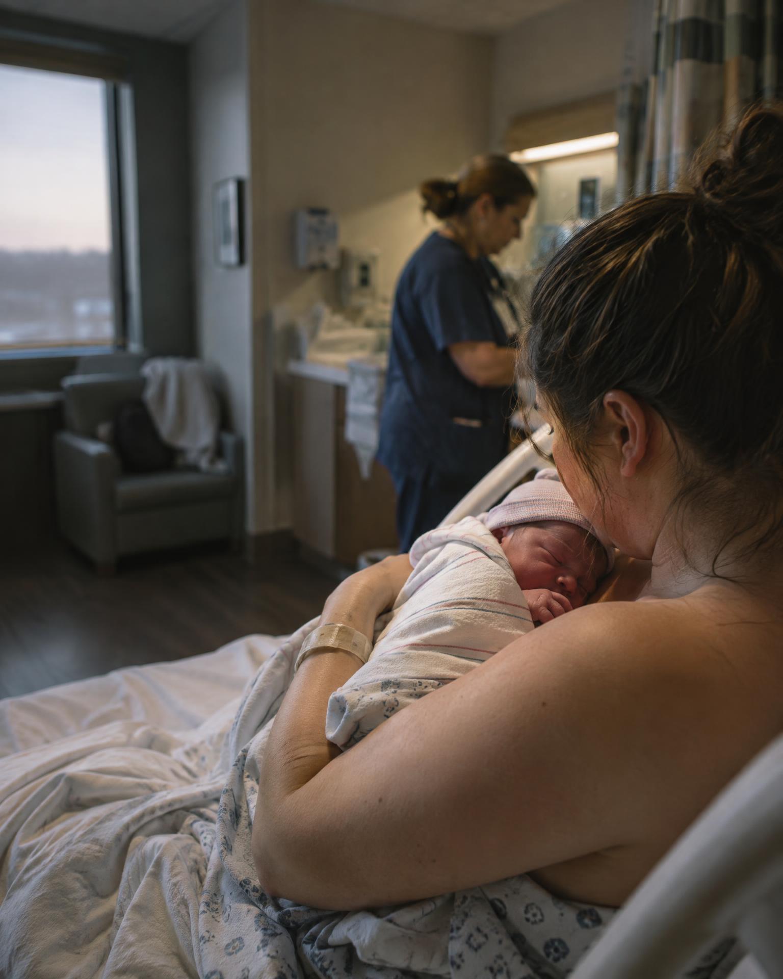 A mother meeting her newborn in a hospital delivery room